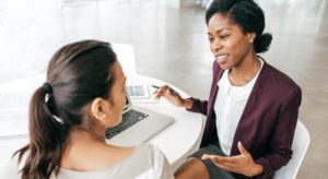 African American Tax Professional helps woman with taxes